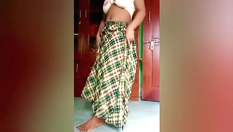 Indian woman wearing a sexy outfit and dancing solo in a bedroom