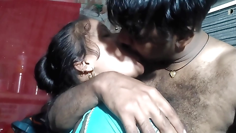 Indian brunette girl is kissing a guy on the floor