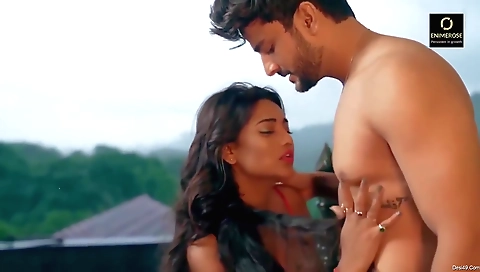 Brunette in a pink dress and a black blazer outdoors on grass