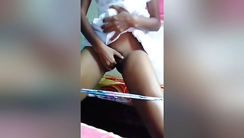 Horny brunette in a black dress and stockings dances