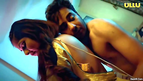 A brunette is in the kitchen and watching her husband