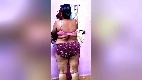 Indian brunette is changing her clothes and panties