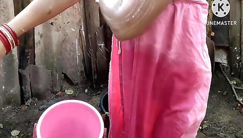 Indian housewife bathing naked outside in her white dress