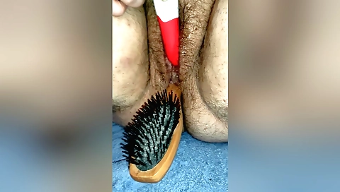 Indian chick with a hairy pussy uses a hairbrush on the couch